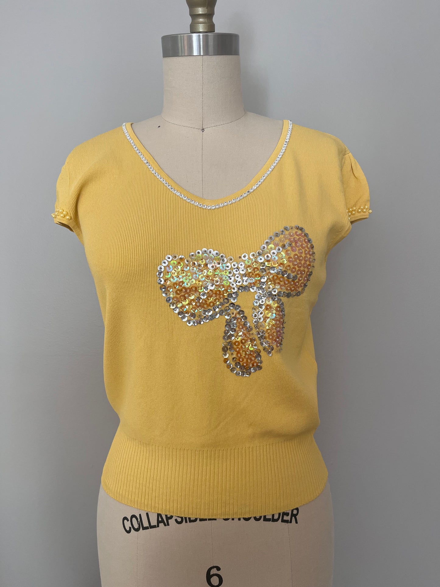 Sequin bow embellished knit top